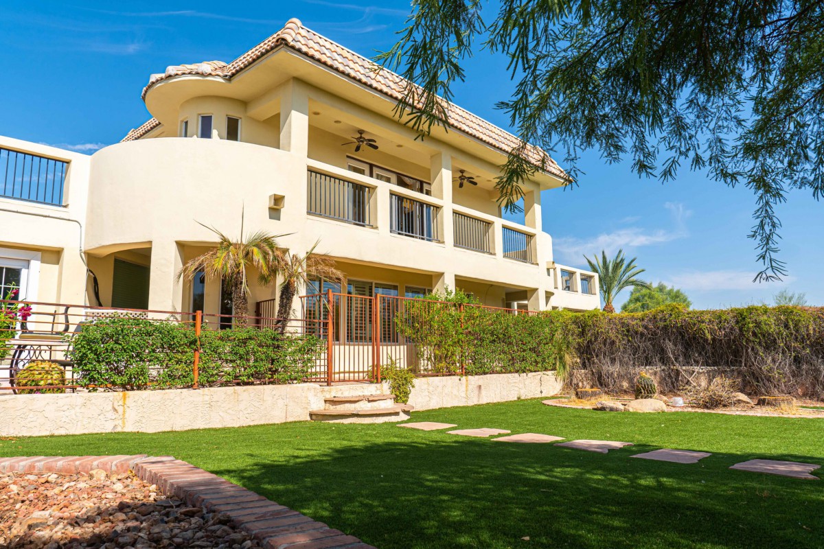 A luxurious residential house with a well-manicured garden and modern architecture.