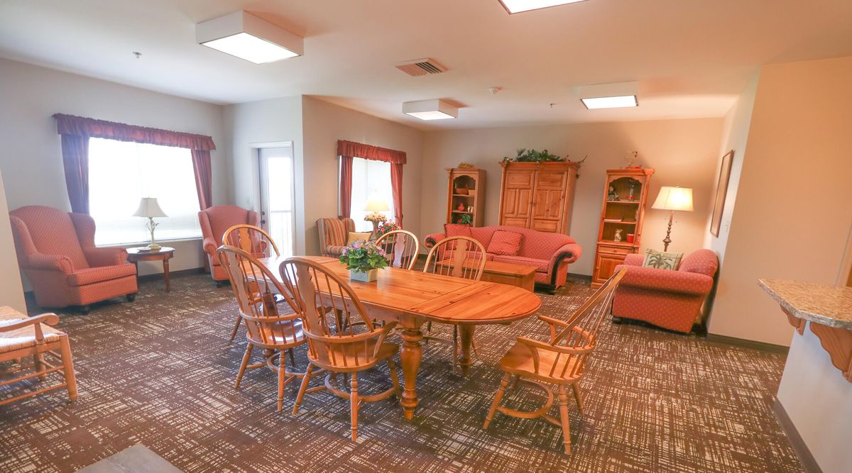 A cozy living and dining area with wooden furniture and a warm ambiance.