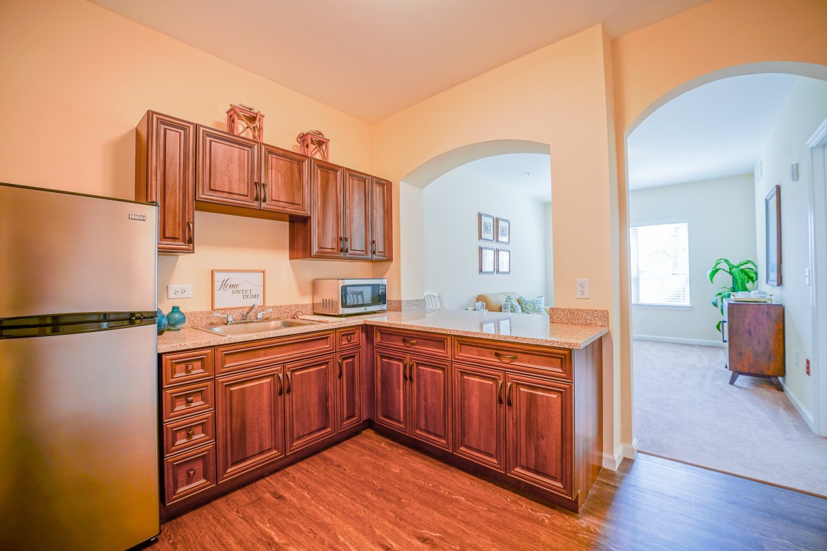 A cozy kitchen with wooden cabinets and modern appliances.