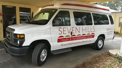 A van promoting Seven Hills Health & Rehabilitation Center, designed for patient transportation.