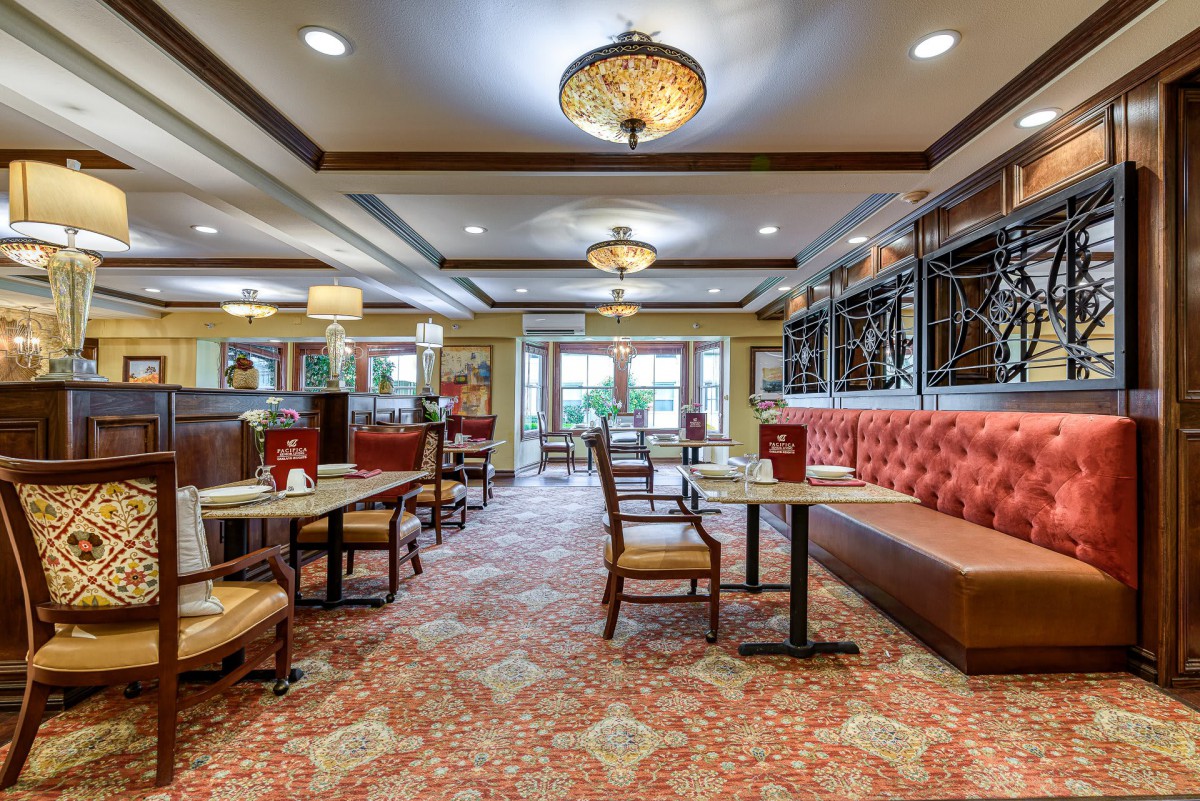 A cozy restaurant interior with elegant lighting and comfortable seating arrangements.