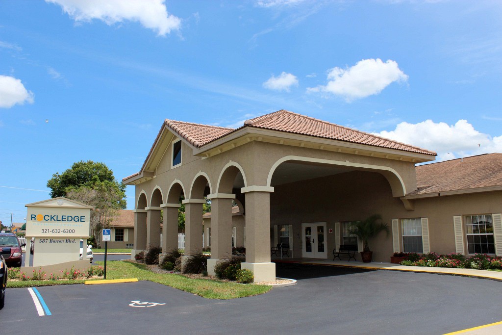A hotel building with arches under a clear blue sky.