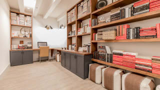 Modern office space with wooden bookshelves and a work desk.