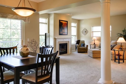 A cozy and inviting living space with a dining area, fireplace, and comfortable seating.