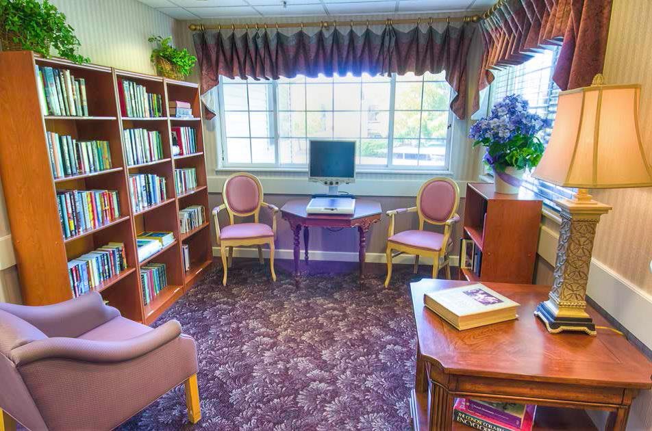 A cozy reading room with bookshelves and seating.