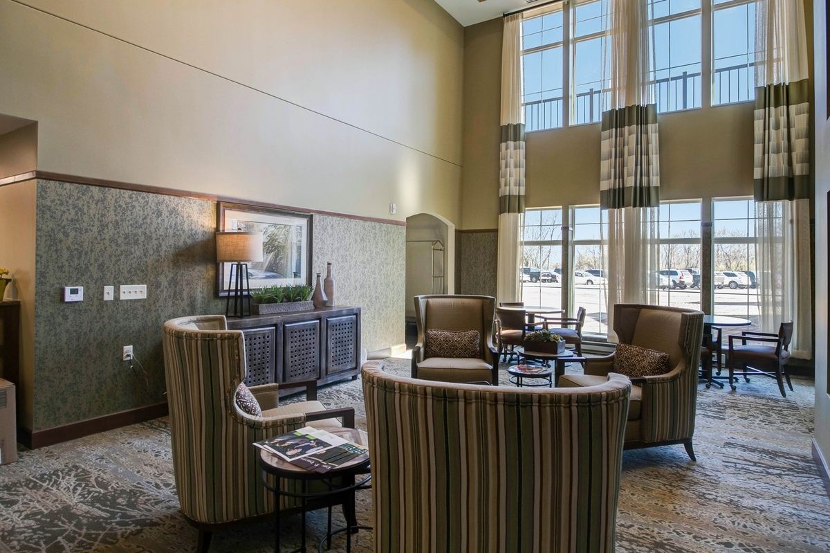 A spacious lobby area with elegant furniture and abundant natural light streaming through large windows.