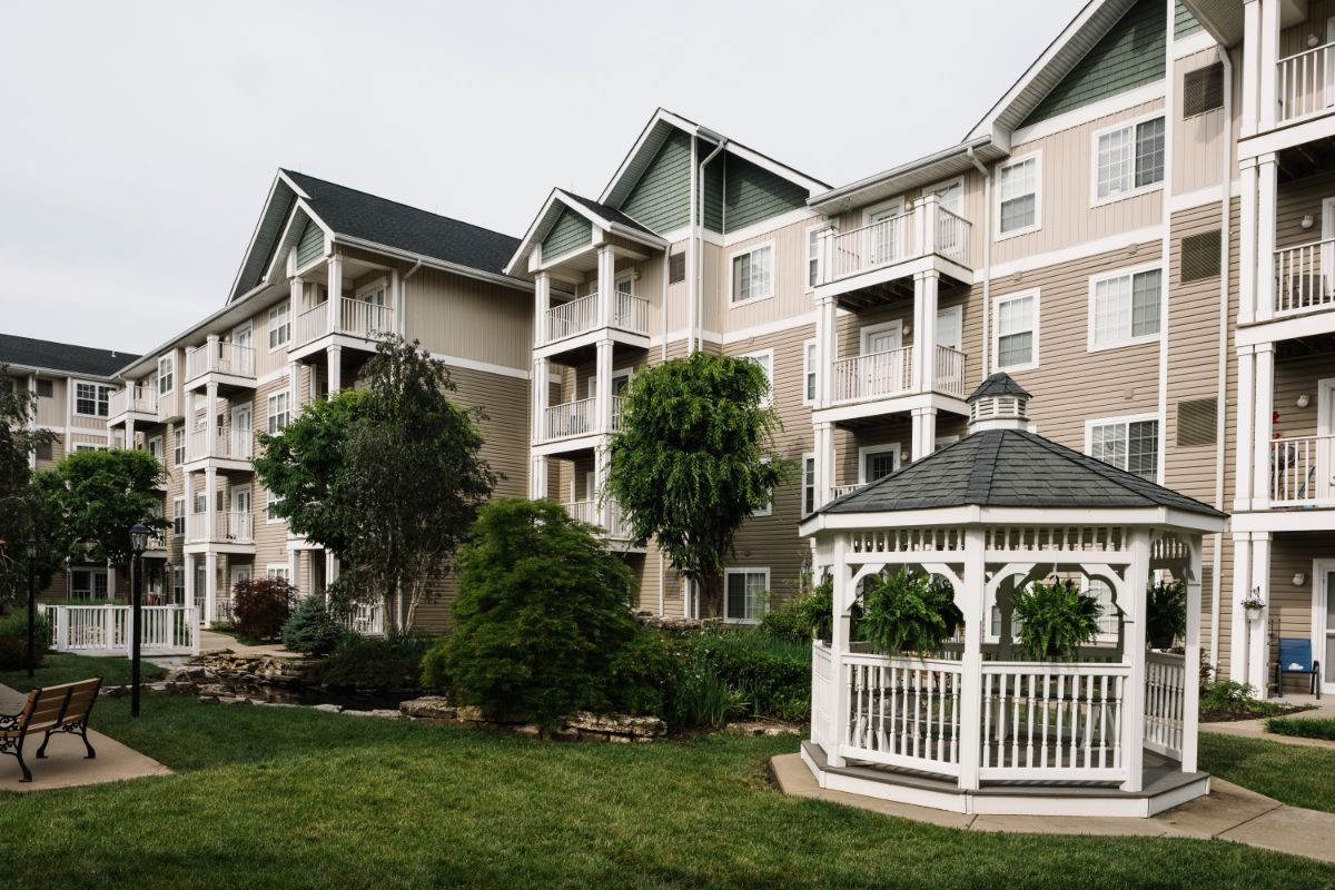 A peaceful residential complex with a gazebo and well-maintained landscaping.