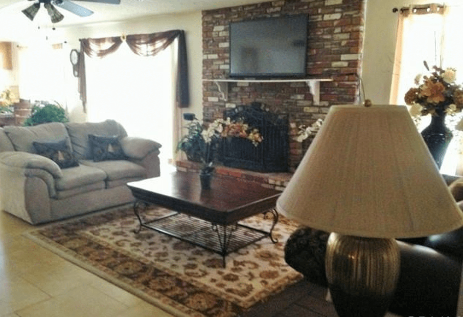Cozy living room with a brick fireplace and modern decor.