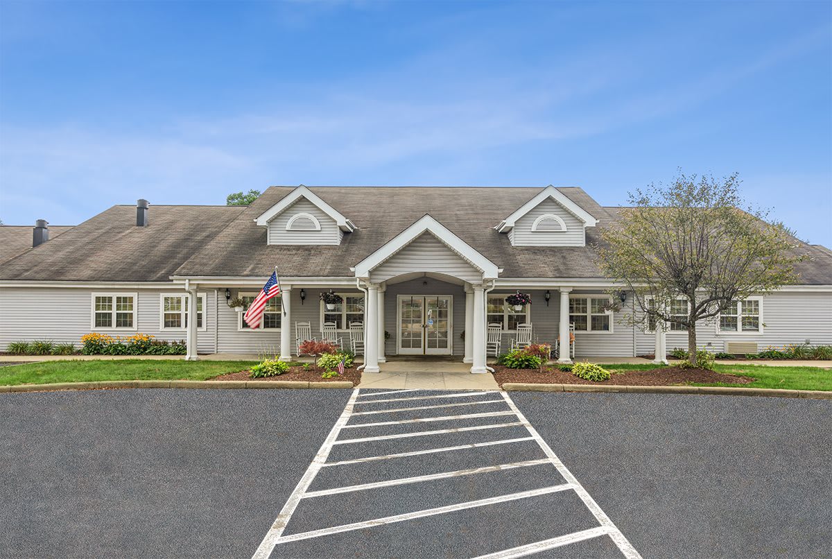 A well-maintained building with a prominent entrance and neatly landscaped surroundings.