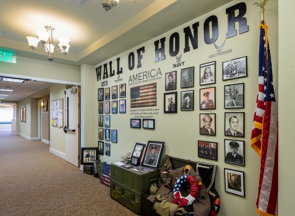 A Wall of Honor featuring photographs and memorabilia dedicated to military veterans.