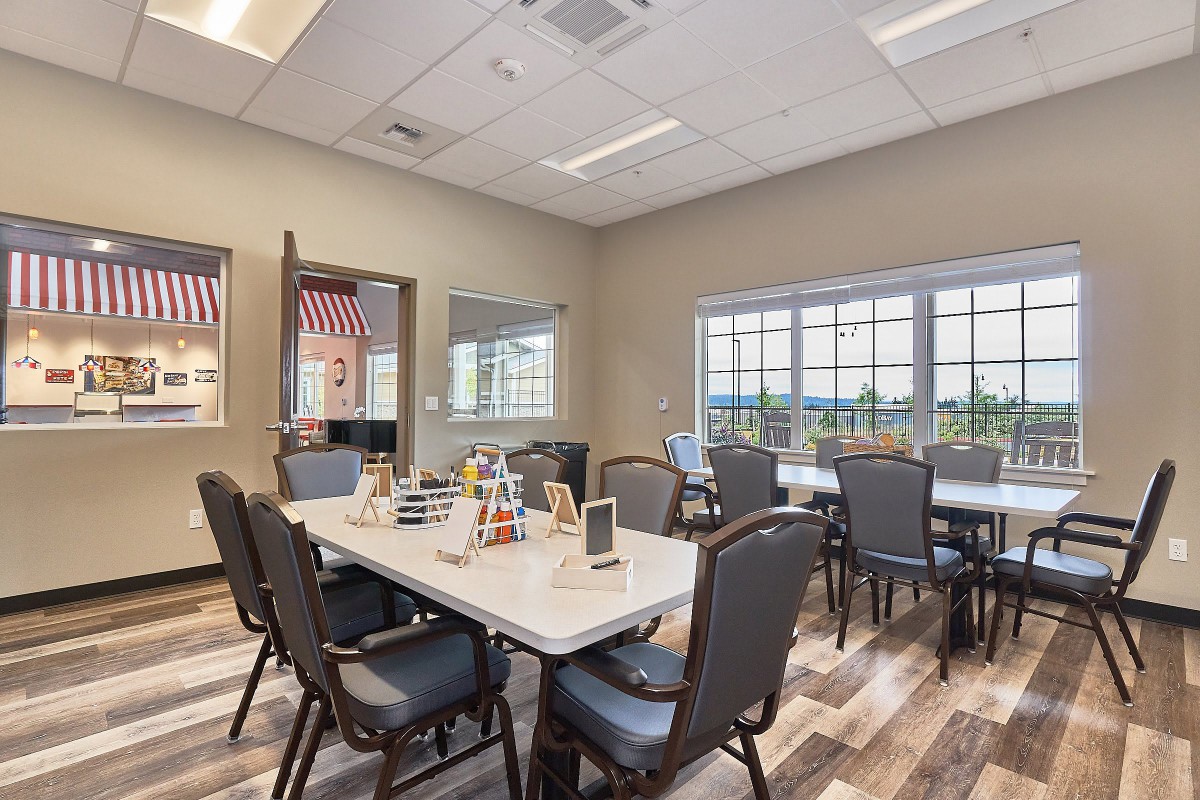 A well-lit conference room with tables and chairs arranged for a meeting.