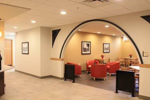 A stylish lobby featuring red seating and elegant wall art, designed for comfort and relaxation.