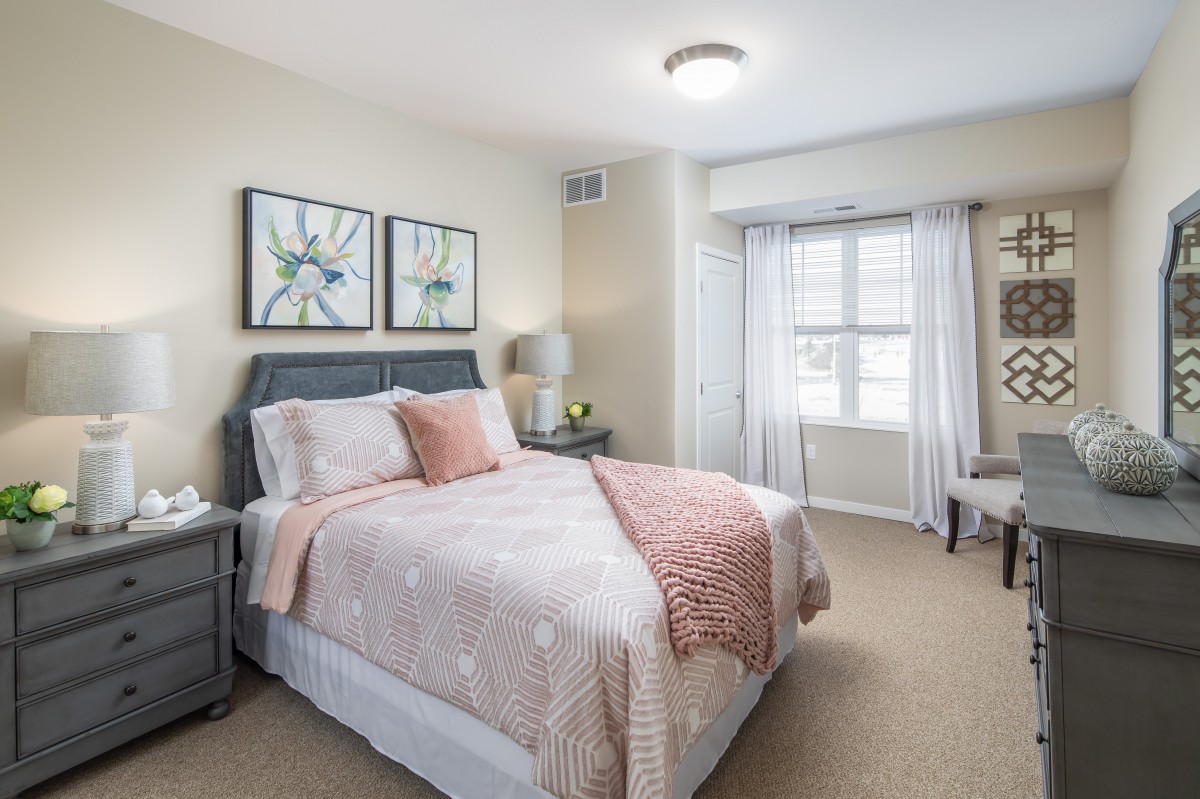 A cozy and well-decorated bedroom with soft colors and elegant furnishings.