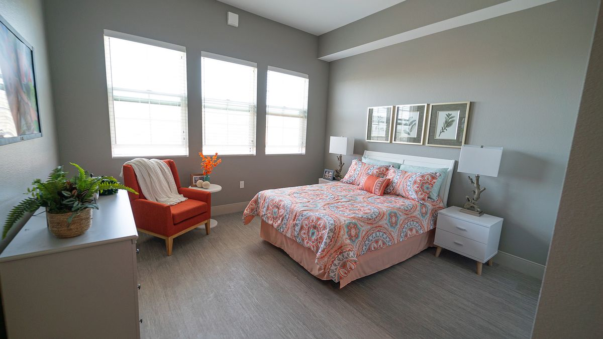 A cozy modern bedroom with stylish decor and ample natural light.