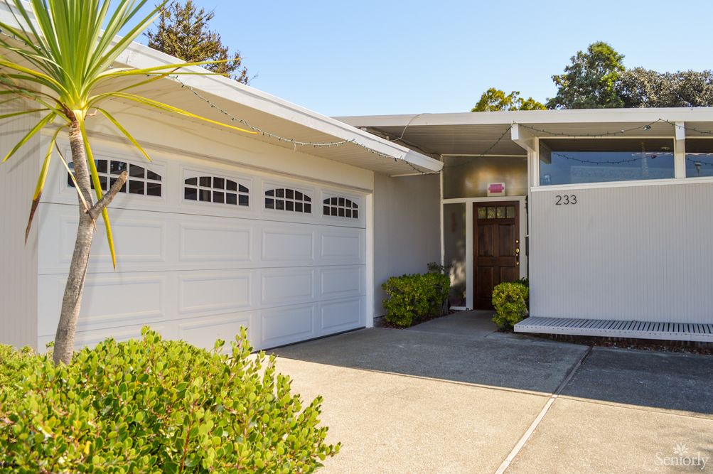 A modern suburban house with a two-car garage and a neatly maintained front yard.