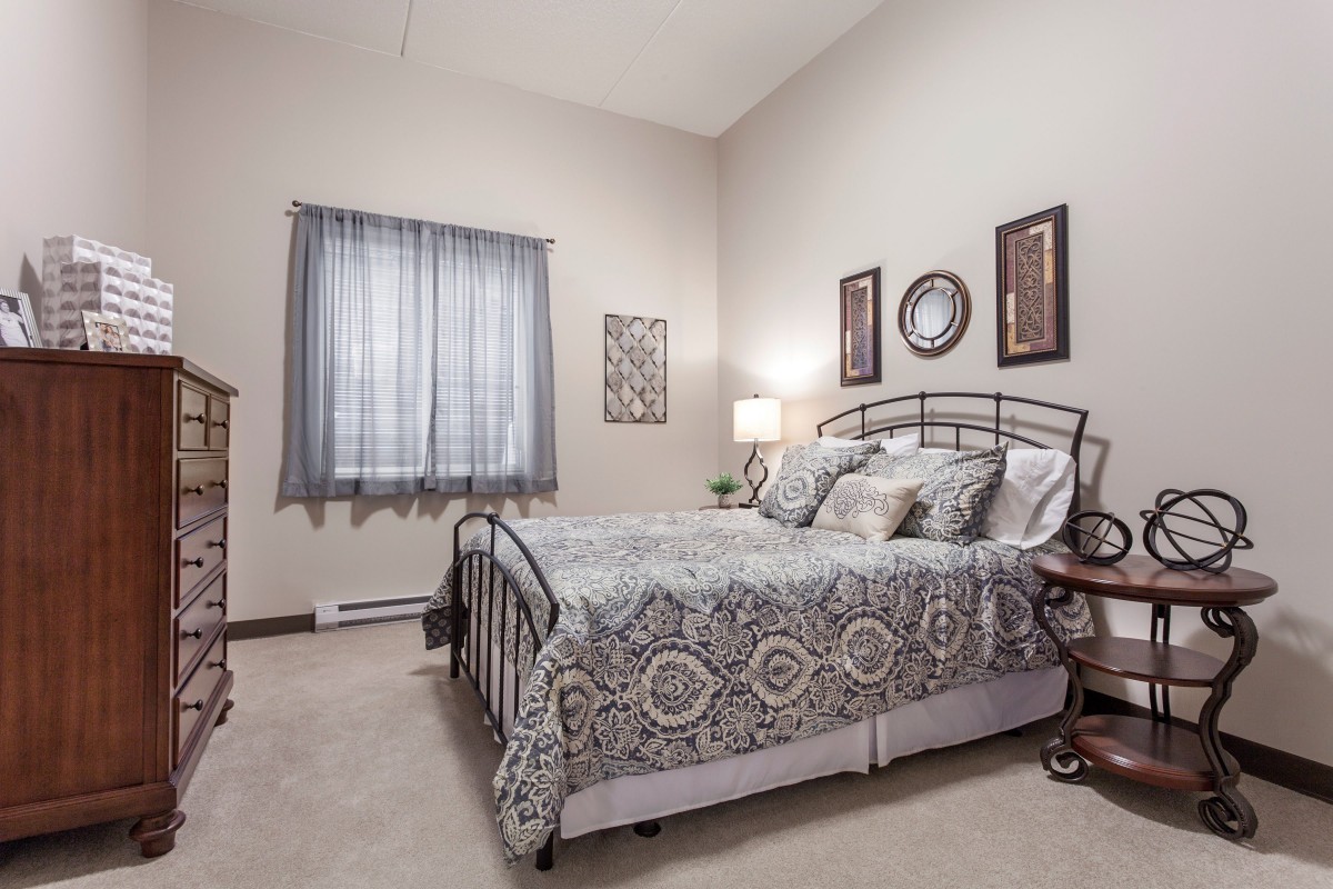A cozy bedroom with decorative elements and a comfortable bed.