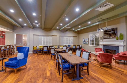 A spacious and well-lit dining area with multiple tables and chairs.