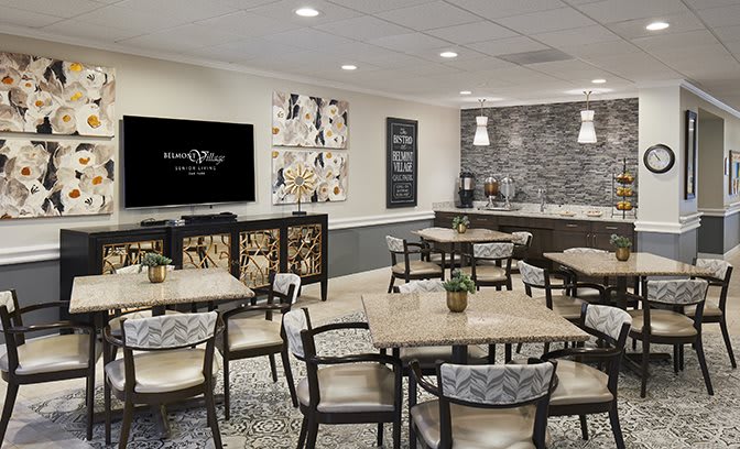 A modern cafe seating area with tables, chairs, wall art, and a coffee station.