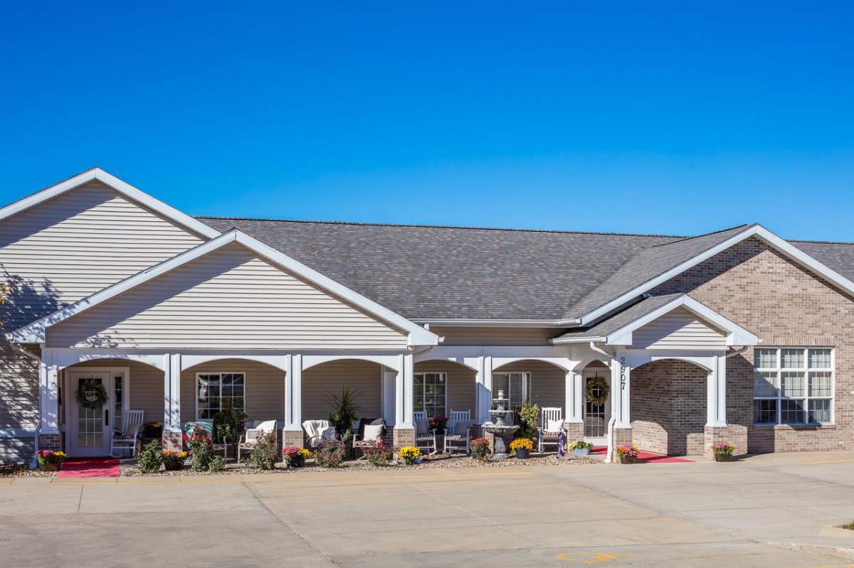 A single-story residential building with a large porch and gabled roof.