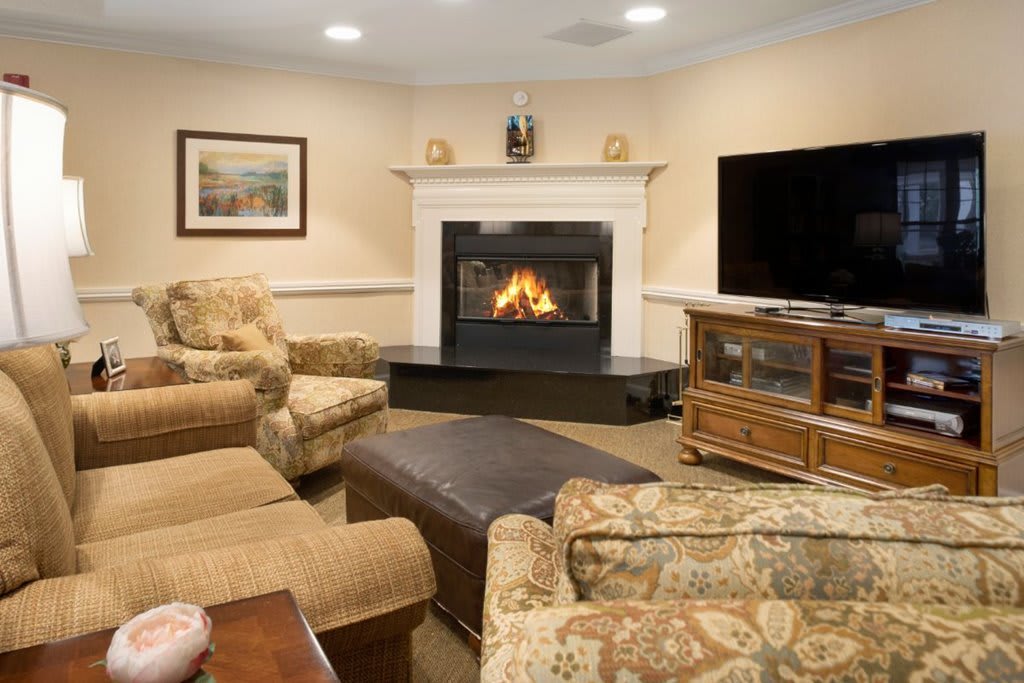A cozy living room featuring a fireplace and comfortable seating arrangements.