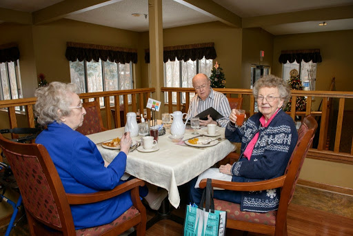 Seniors enjoying breakfast together in a cozy dining area.