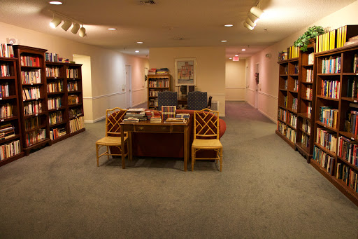 A cozy library space featuring bookshelves and comfortable seating.