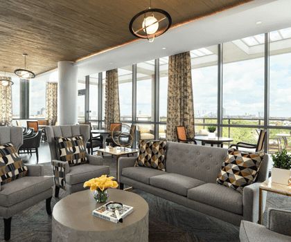 A modern lounge area with comfortable seating and large windows allowing natural light.