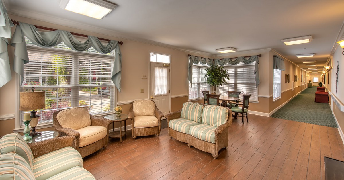 A cozy living room with comfortable seating, large windows, and elegant decor.