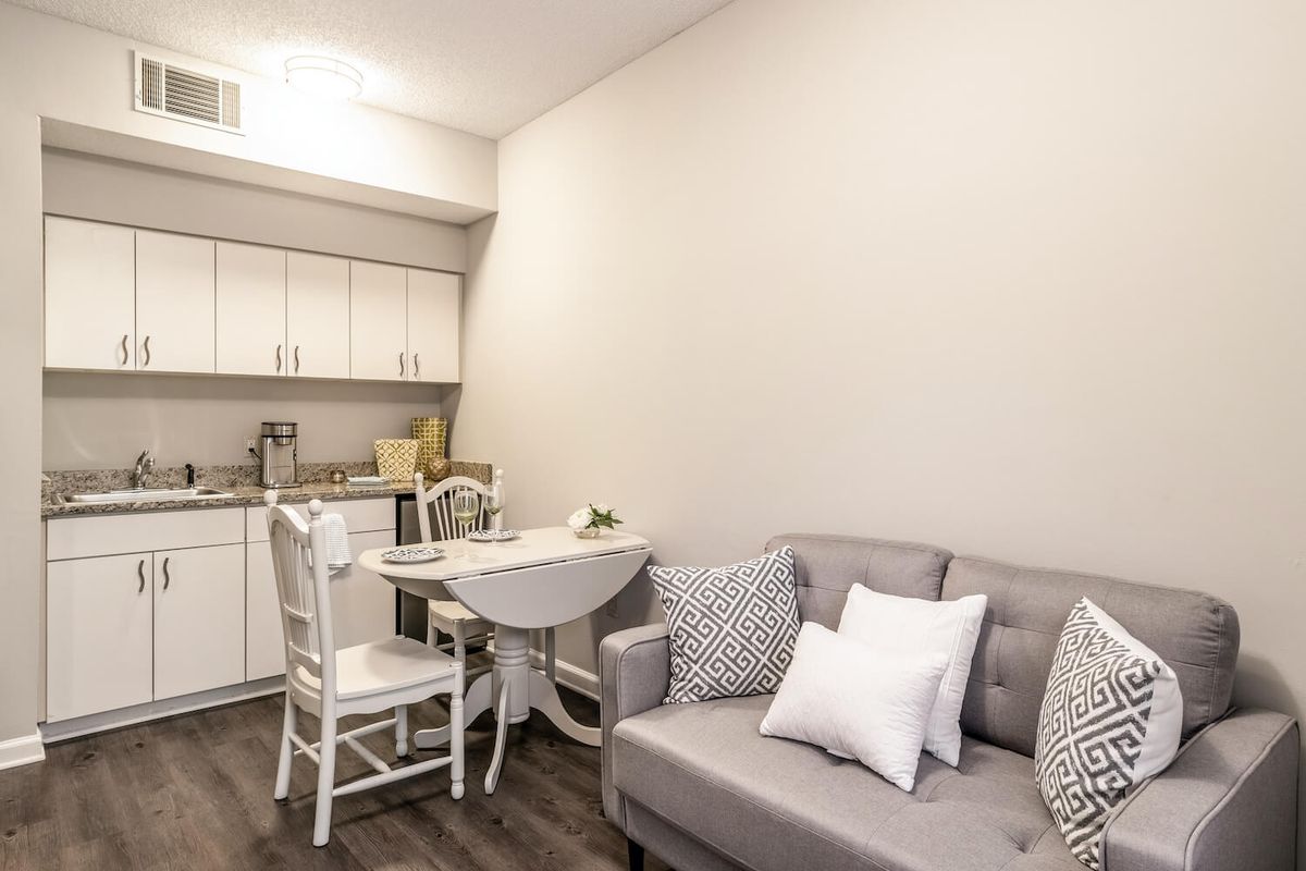 Compact living space with a kitchenette and a cozy seating area.