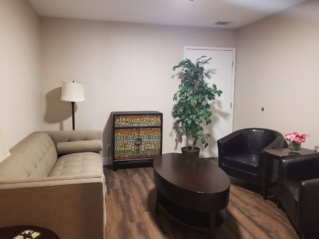 Cozy living room with a sofa, armchair, and coffee table.