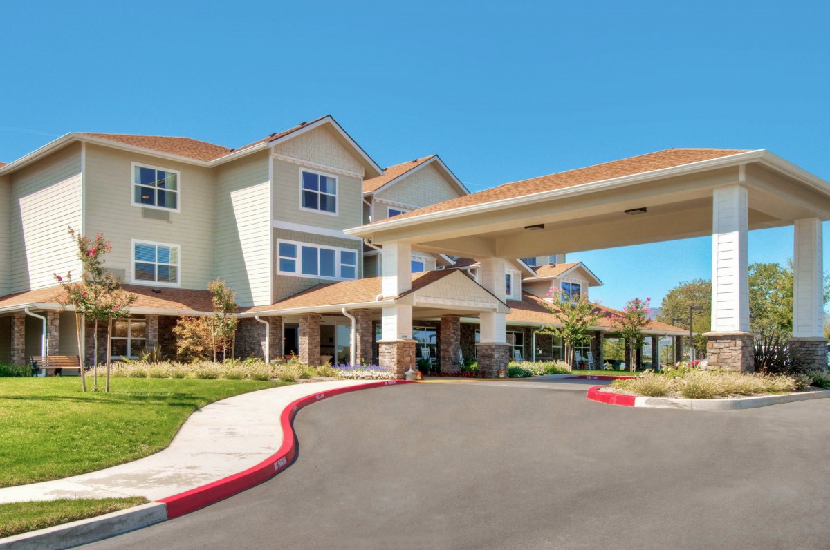 A well-maintained building with an inviting entrance and landscaped surroundings.