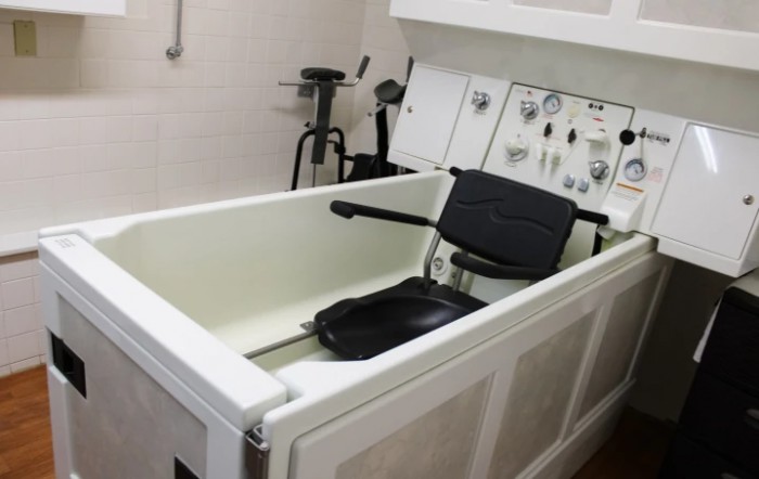 A hydrotherapy tub equipped for rehabilitation and therapy purposes in a healthcare setting.