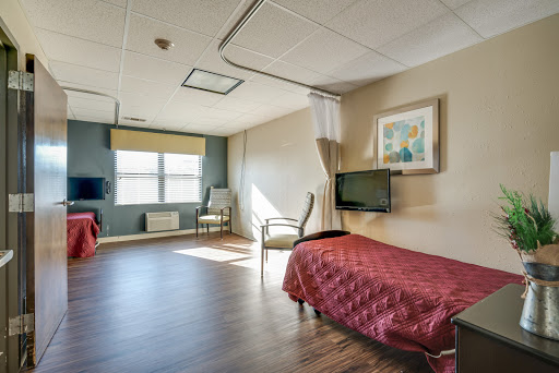 A bright and spacious hospital room designed for patient comfort.