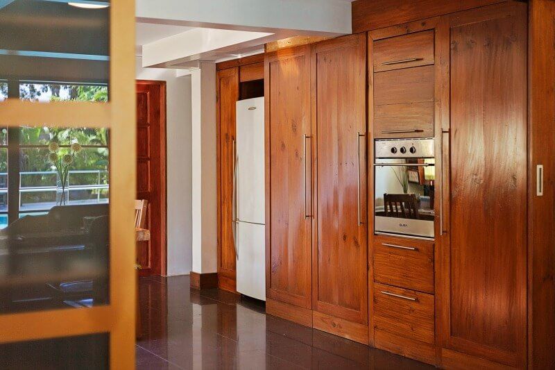 A modern kitchen with wooden cabinets and built-in appliances.