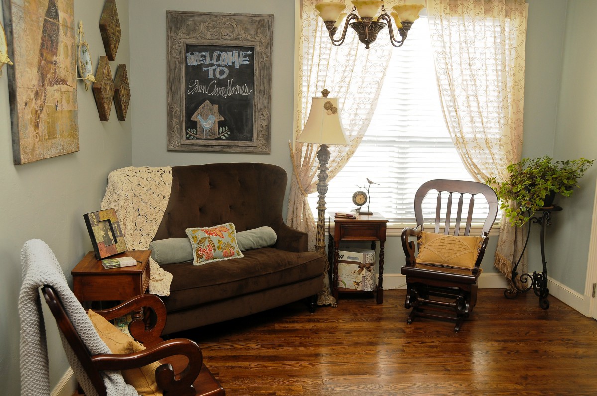 Cozy living room with a sofa, rocking chair, and decorative elements.