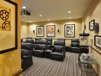 A cozy home theater room with comfortable seating and classic movie posters.