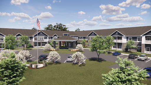 A welcoming hotel entrance surrounded by lush greenery and a clear blue sky.