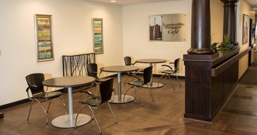 An empty, modern cafe interior with tables and chairs arranged neatly.