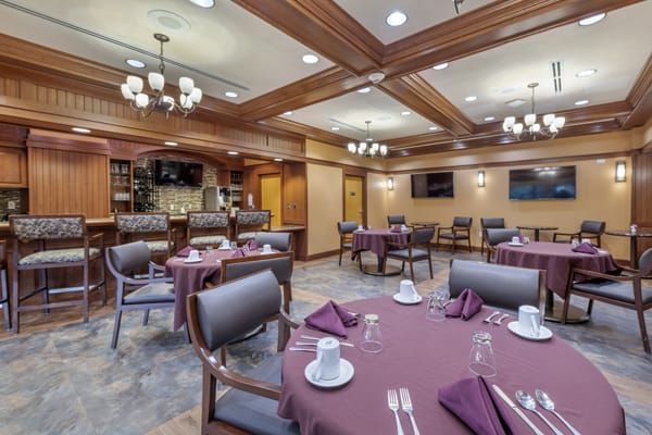A well-decorated dining area with neatly arranged tables and chairs, ready for guests.