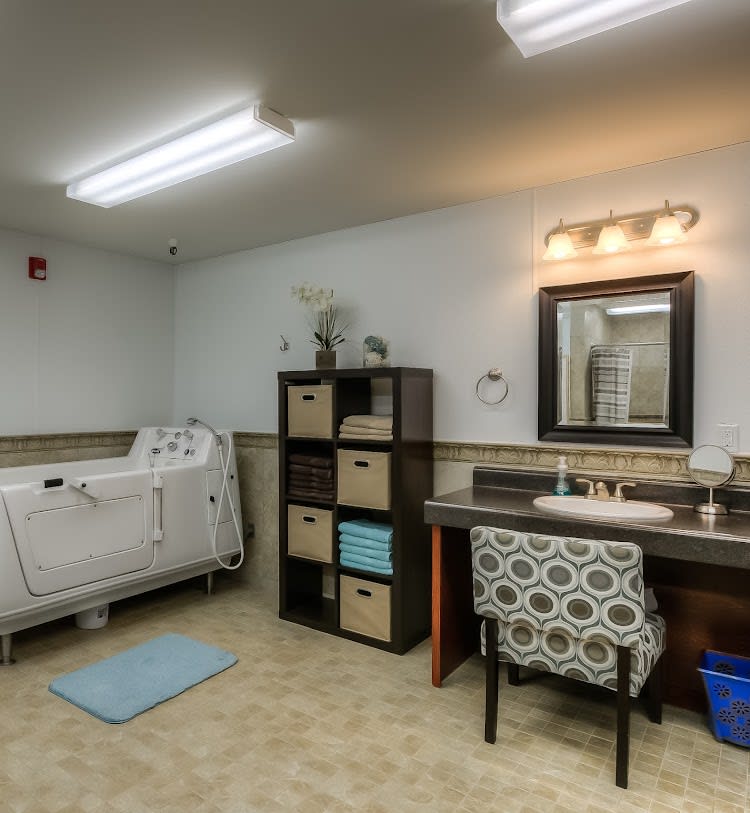 Spacious bathroom with a modern bathtub, vanity area, and organized shelving.