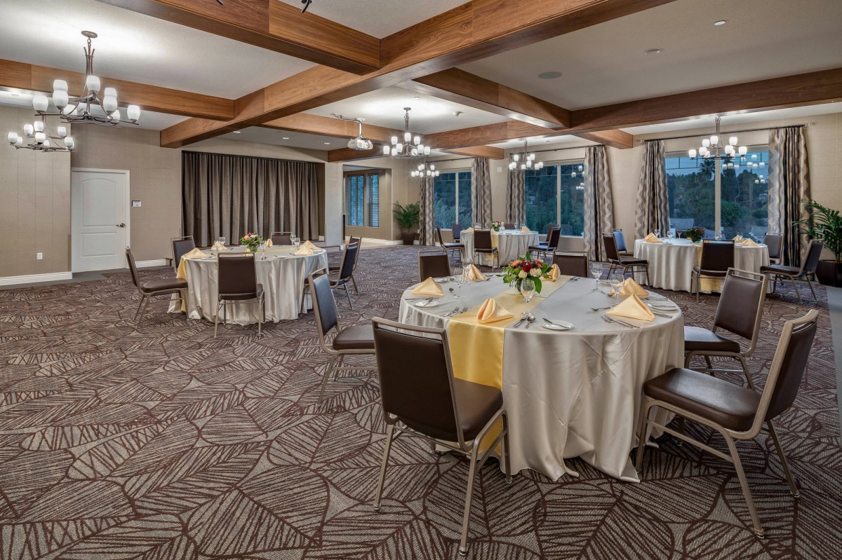An elegant banquet hall set up with tables and chairs, ready for an event.