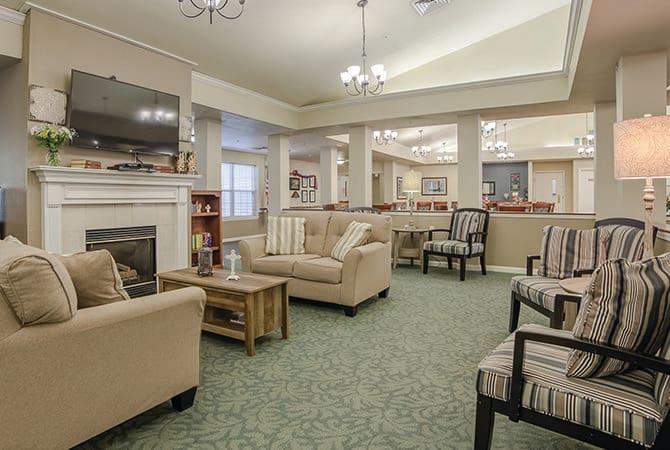 A cozy and spacious living room with comfortable seating and a fireplace.