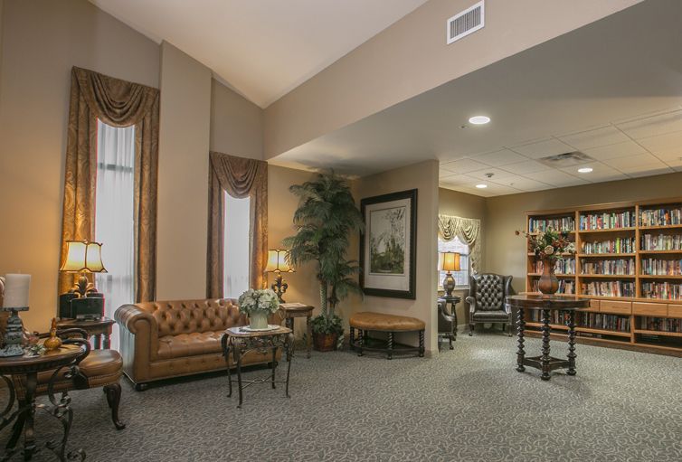 A traditional and cozy living room with elegant furnishings and warm lighting.