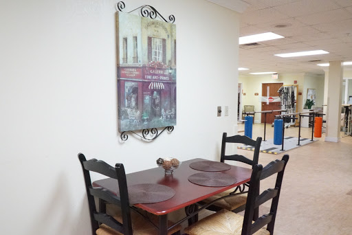 A cozy dining area featuring a wooden table and chairs, complemented by a decorative wall art piece.