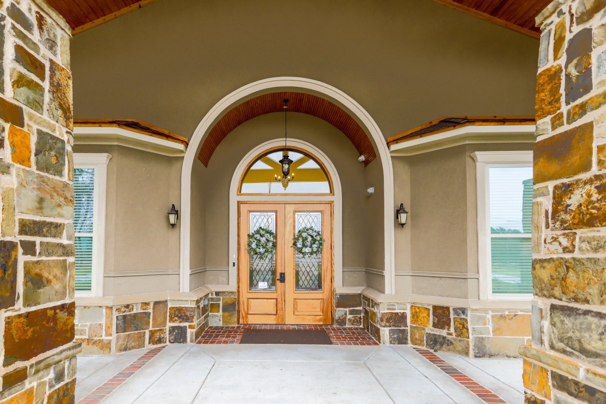 A welcoming front entrance with double doors and an arched design.