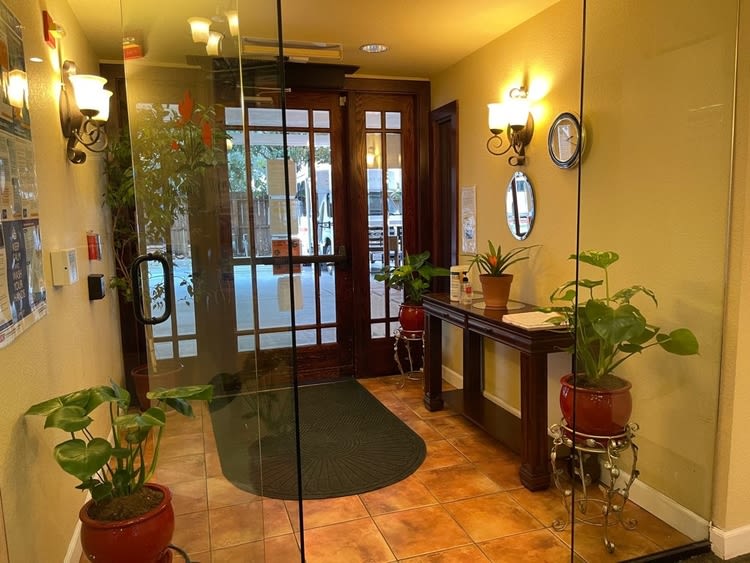 A cozy entrance lobby with plants and warm lighting.