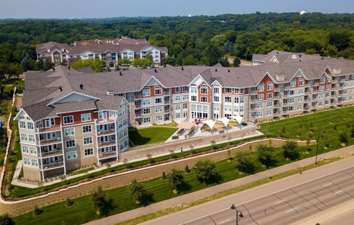 Aerial view of a residential apartment complex surrounded by greenery.
