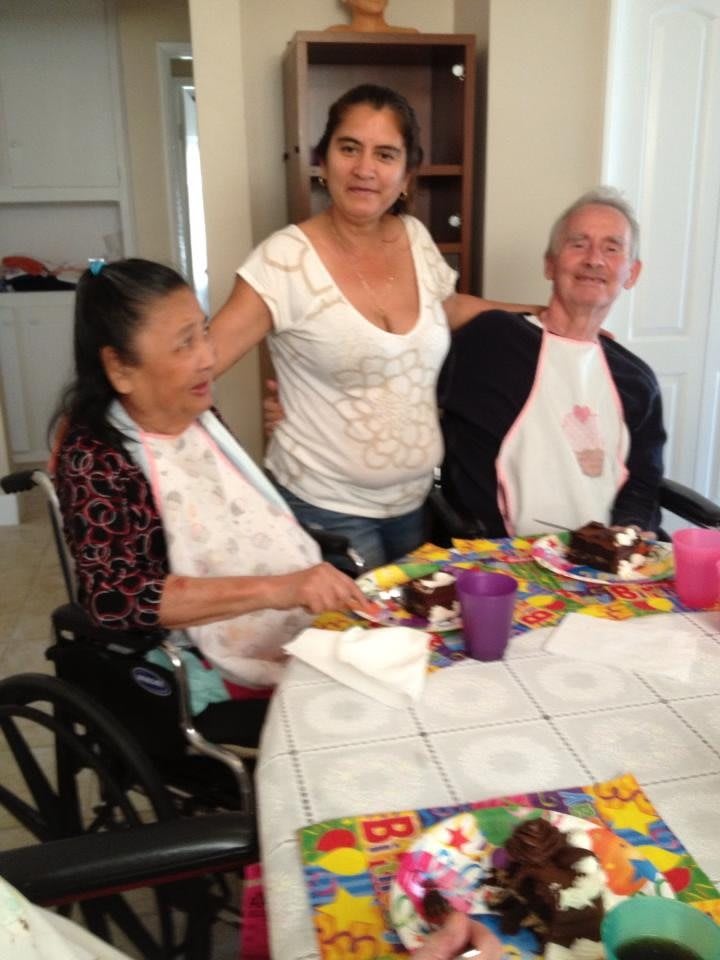 A group of people enjoying a meal together, celebrating an occasion.