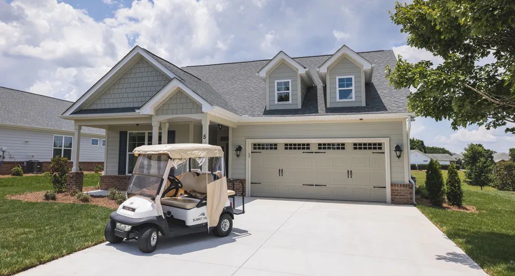 A suburban home with a golf cart parked in the driveway.