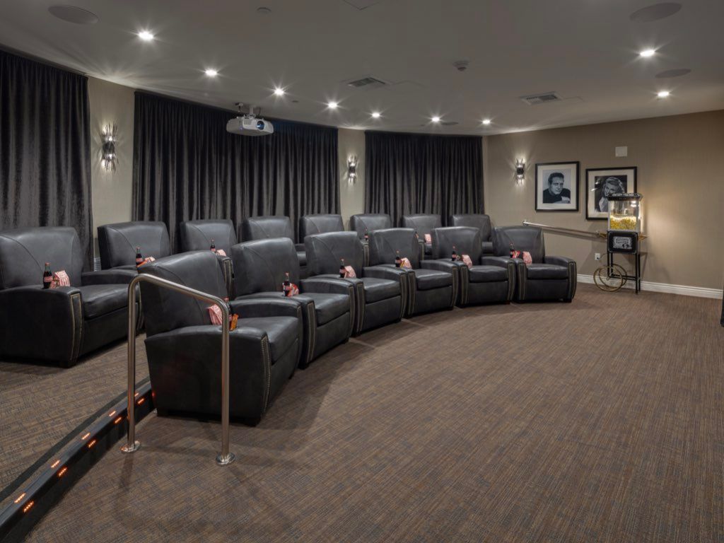 A home theater room with comfortable seating and ambient lighting.